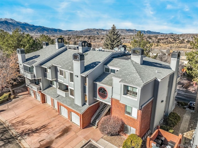 birds eye view of property with a mountain view