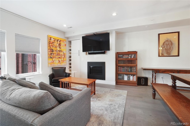 living room with hardwood / wood-style flooring and ornamental molding