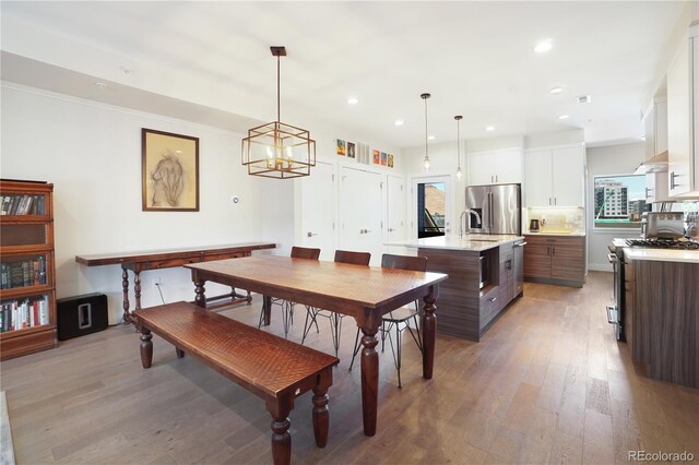 dining area featuring hardwood / wood-style flooring and a notable chandelier