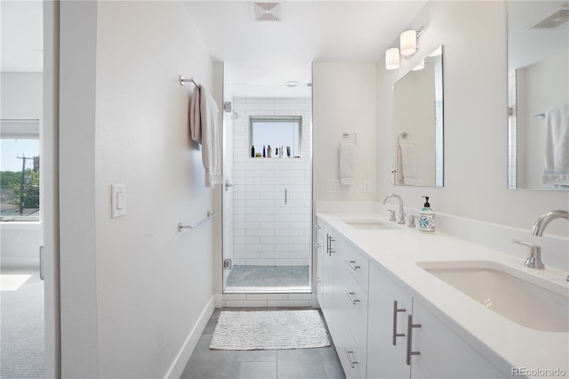 bathroom with tile patterned flooring, an enclosed shower, and vanity