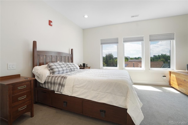 bedroom with lofted ceiling and light colored carpet