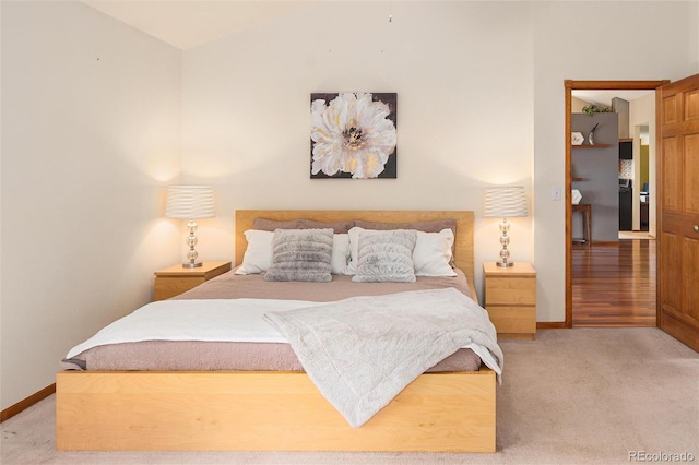 11163 Conifer Mountain Rd, Conifer, CO 80433 - bedroom with baseboards, light carpet, and lofted ceiling