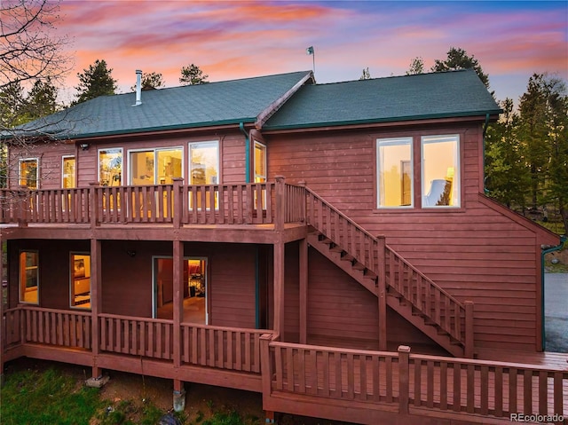 11163 Conifer Mountain Rd, Conifer, CO 80433 - back of house at dusk with stairs and a deck