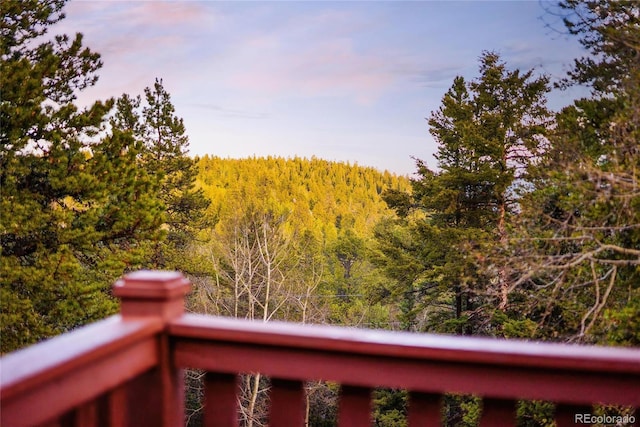 11163 Conifer Mountain Rd, Conifer, CO 80433 - balcony featuring a wooded view