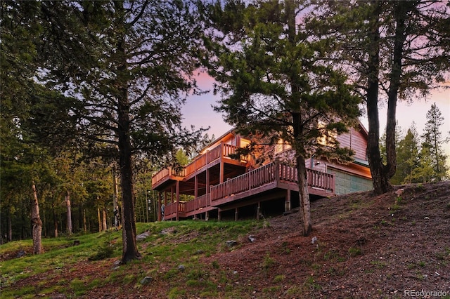 11163 Conifer Mountain Rd, Conifer, CO 80433 - back of property at dusk featuring a wooden deck