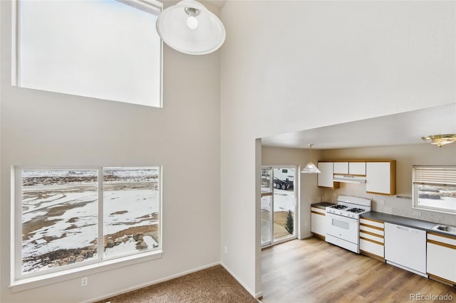 109 Gcr 823, Tabernash, CO 80478 - kitchen with white appliances, ventilation hood, white cabinets, a high ceiling, and dark countertops
