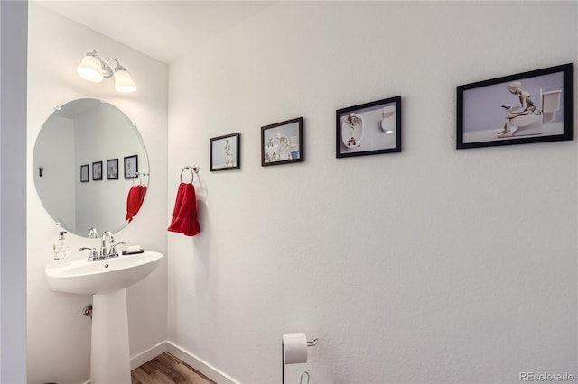 bathroom featuring baseboards and wood finished floors