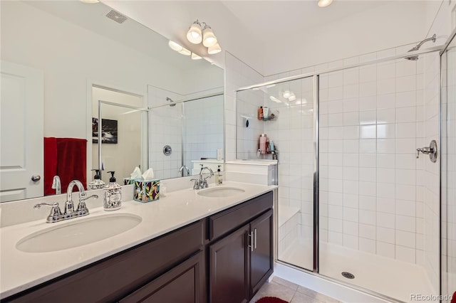 full bathroom with a stall shower, a sink, and tile patterned floors