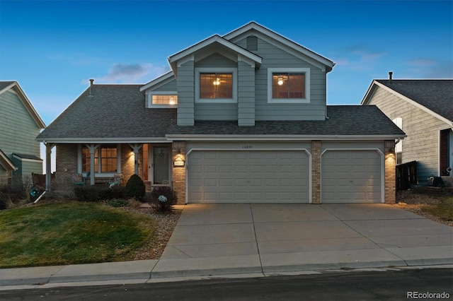 view of front facade with a yard and a garage