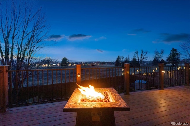 deck at dusk with a fire pit