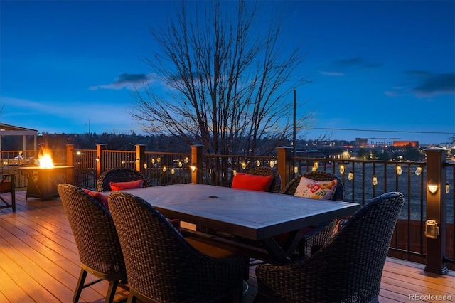 deck at dusk with an outdoor fire pit