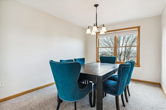 dining space with a chandelier and carpet