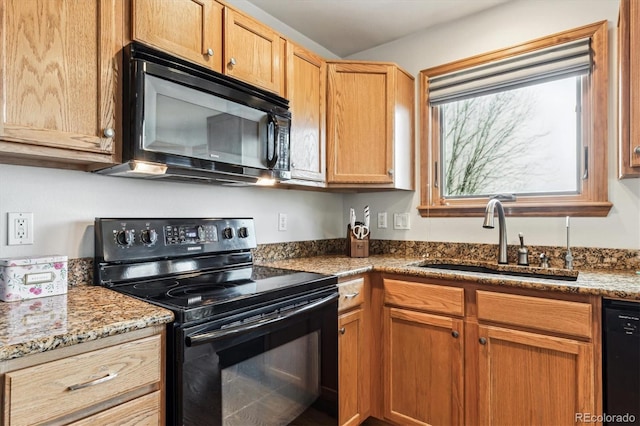 kitchen featuring light stone countertops, sink, and black appliances