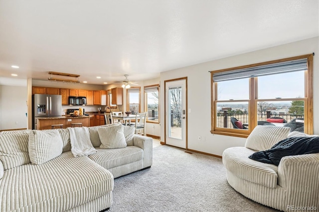 living room featuring ceiling fan and light carpet