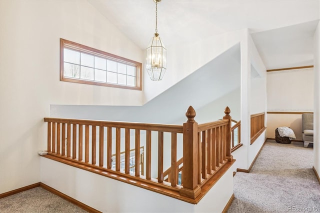 interior space featuring lofted ceiling, carpet flooring, and a chandelier