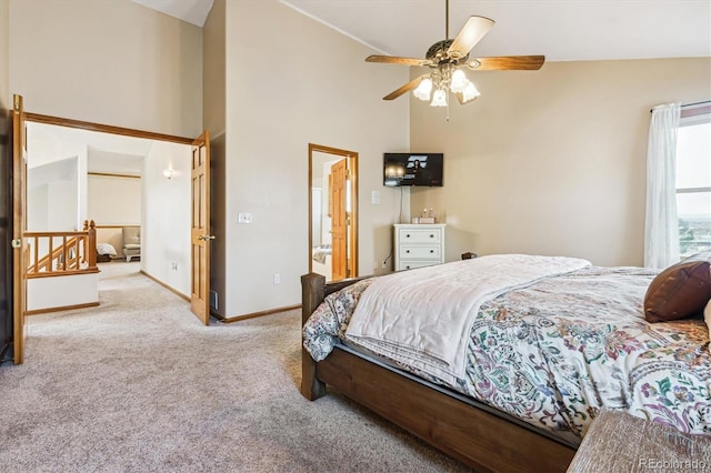 carpeted bedroom featuring high vaulted ceiling, connected bathroom, and ceiling fan