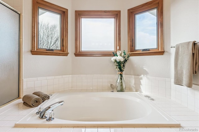 bathroom featuring tiled tub