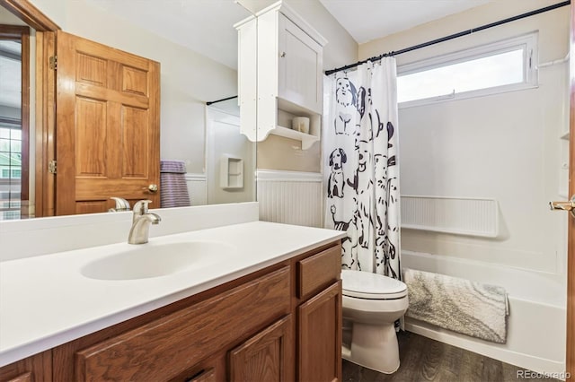 full bathroom with shower / tub combo with curtain, a healthy amount of sunlight, wood-type flooring, and vanity