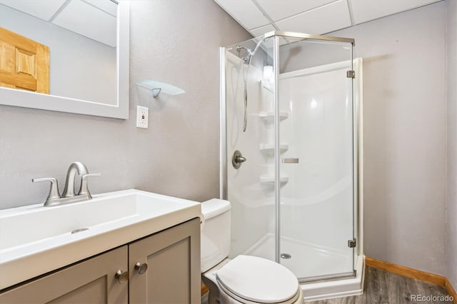 bathroom with vanity, wood-type flooring, a shower with door, and toilet