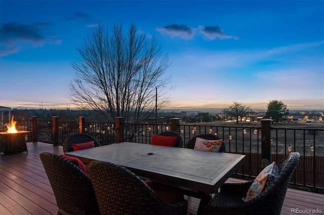 deck at dusk with a fire pit