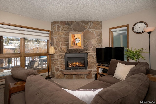 living room featuring a textured ceiling, carpet flooring, and a stone fireplace