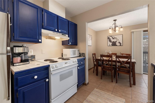 kitchen with a notable chandelier, tile counters, blue cabinets, and white appliances