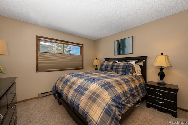 carpeted bedroom with a baseboard heating unit and a textured ceiling