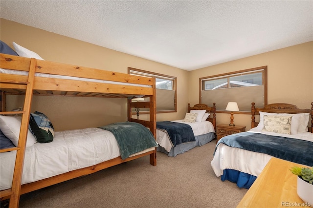 carpeted bedroom featuring a textured ceiling