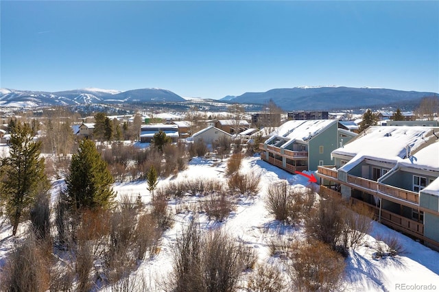 snowy aerial view featuring a mountain view