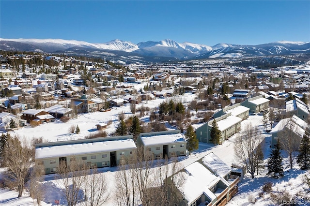 snowy aerial view featuring a mountain view