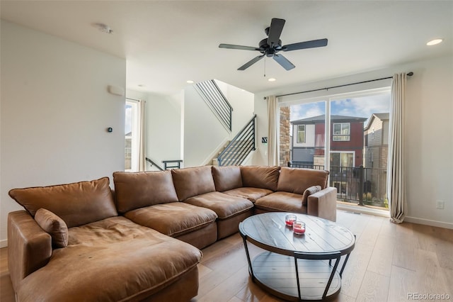 living room featuring ceiling fan and light wood-type flooring