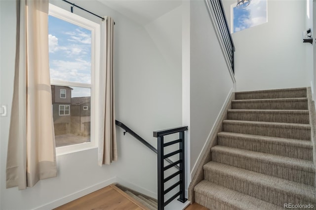 stairs featuring hardwood / wood-style flooring