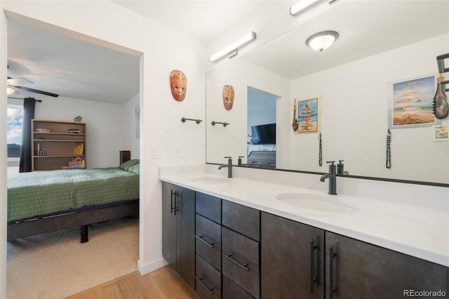 bathroom featuring wood-type flooring, vanity, and ceiling fan