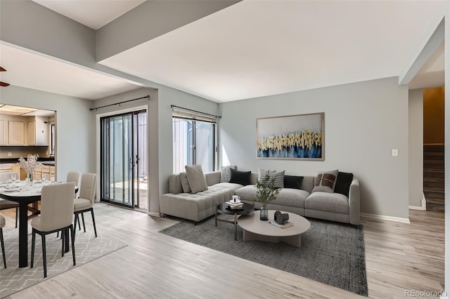 living room with light wood finished floors and baseboards