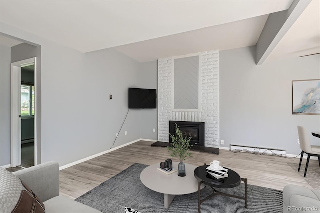 living room featuring baseboard heating, wood finished floors, and baseboards