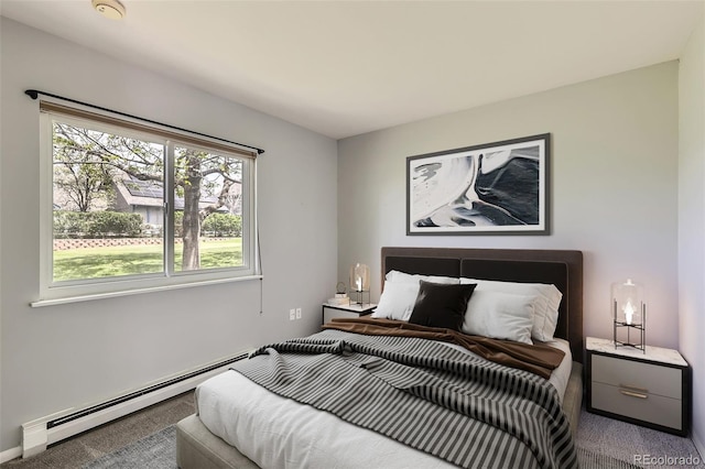 bedroom with baseboard heating and carpet