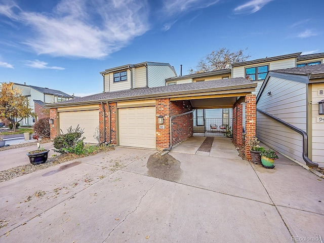 view of front of property with a carport and a garage