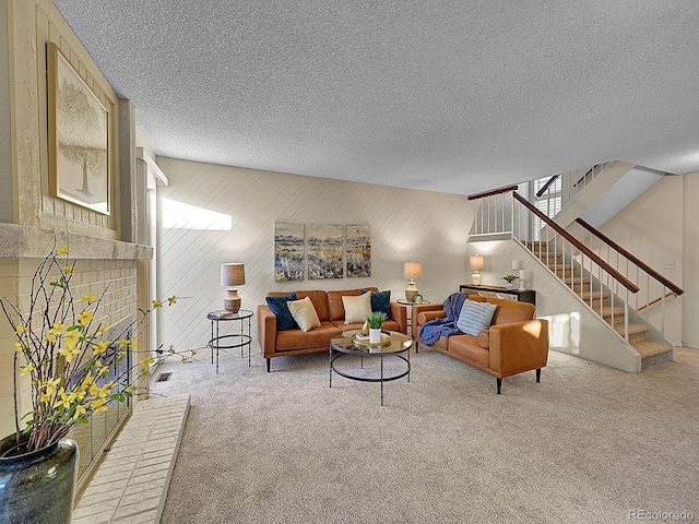 living room featuring carpet flooring and a textured ceiling