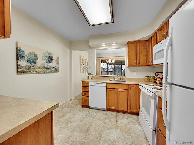 kitchen with pendant lighting, white appliances, a notable chandelier, and sink