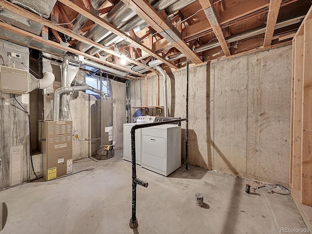 basement with washer and clothes dryer, gas water heater, and heating unit