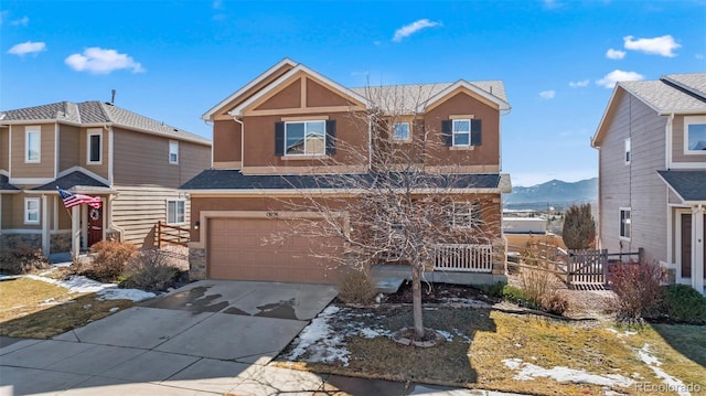 view of front facade featuring driveway, an attached garage, fence, and stucco siding