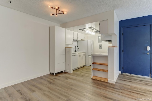 8555 Fairmount Dr Unit C202, Denver, CO 80247 - kitchen featuring white appliances, light wood-type flooring, a sink, light countertops, and a textured ceiling