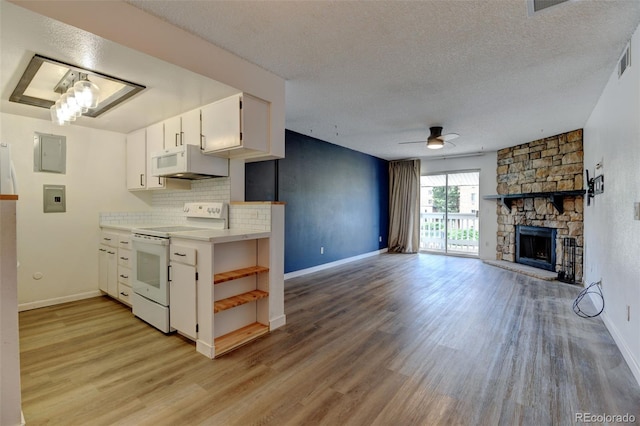 8555 Fairmount Dr Unit C202, Denver, CO 80247 - kitchen featuring white appliances, ceiling fan, white cabinets, open shelves, and light wood-style floors