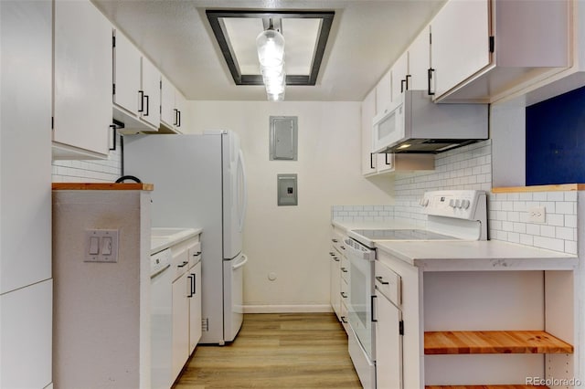 8555 Fairmount Dr Unit C202, Denver, CO 80247 - kitchen featuring white appliances, light countertops, light wood-type flooring, decorative backsplash, and white cabinetry