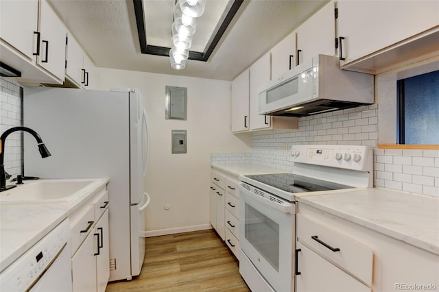 8555 Fairmount Dr Unit C202, Denver, CO 80247 - kitchen featuring white appliances, a sink, white cabinets, and decorative backsplash