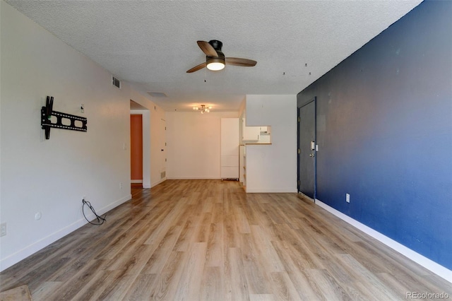 8555 Fairmount Dr Unit C202, Denver, CO 80247 - spare room with ceiling fan, light wood-style flooring, a textured ceiling, and baseboards