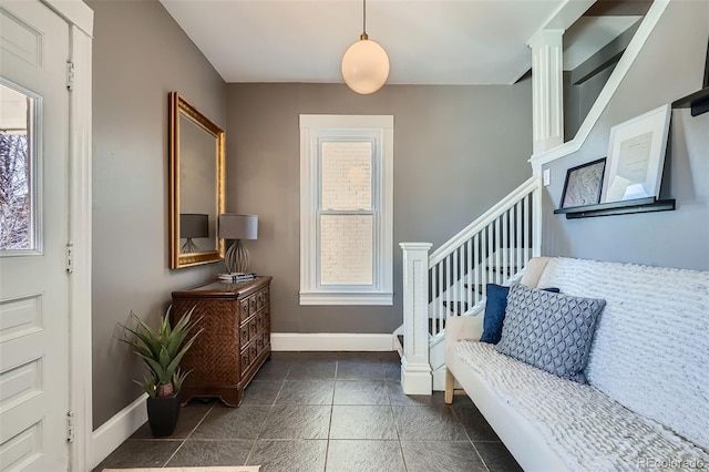 entrance foyer featuring stairs and baseboards