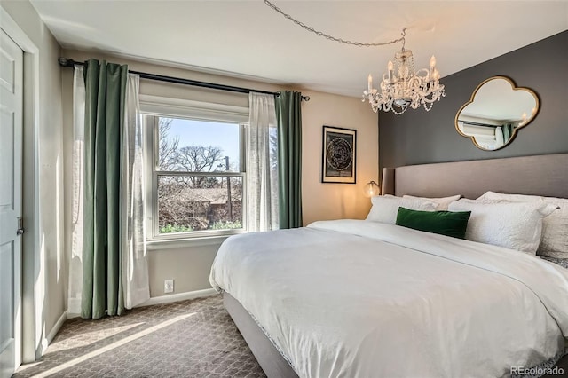 bedroom featuring carpet floors, a chandelier, and baseboards