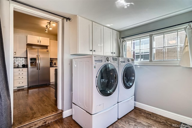 laundry room featuring cabinet space, washing machine and dryer, baseboards, and dark wood-style flooring