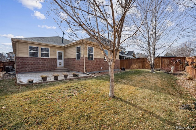 back of property with a lawn, a patio area, and central air condition unit